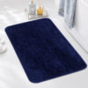 Blissful Creations navy blue super absorbent bath mat with soft textured surface and rounded corners placed in a modern bathroom