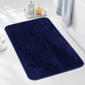 Blissful Creations navy blue super absorbent bath mat with soft textured surface and rounded corners placed in a modern bathroom